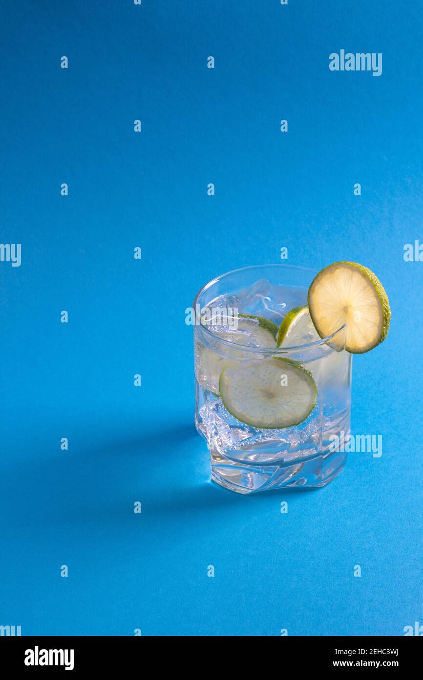 Ice cold drink with lime slices attached Stock Photo
