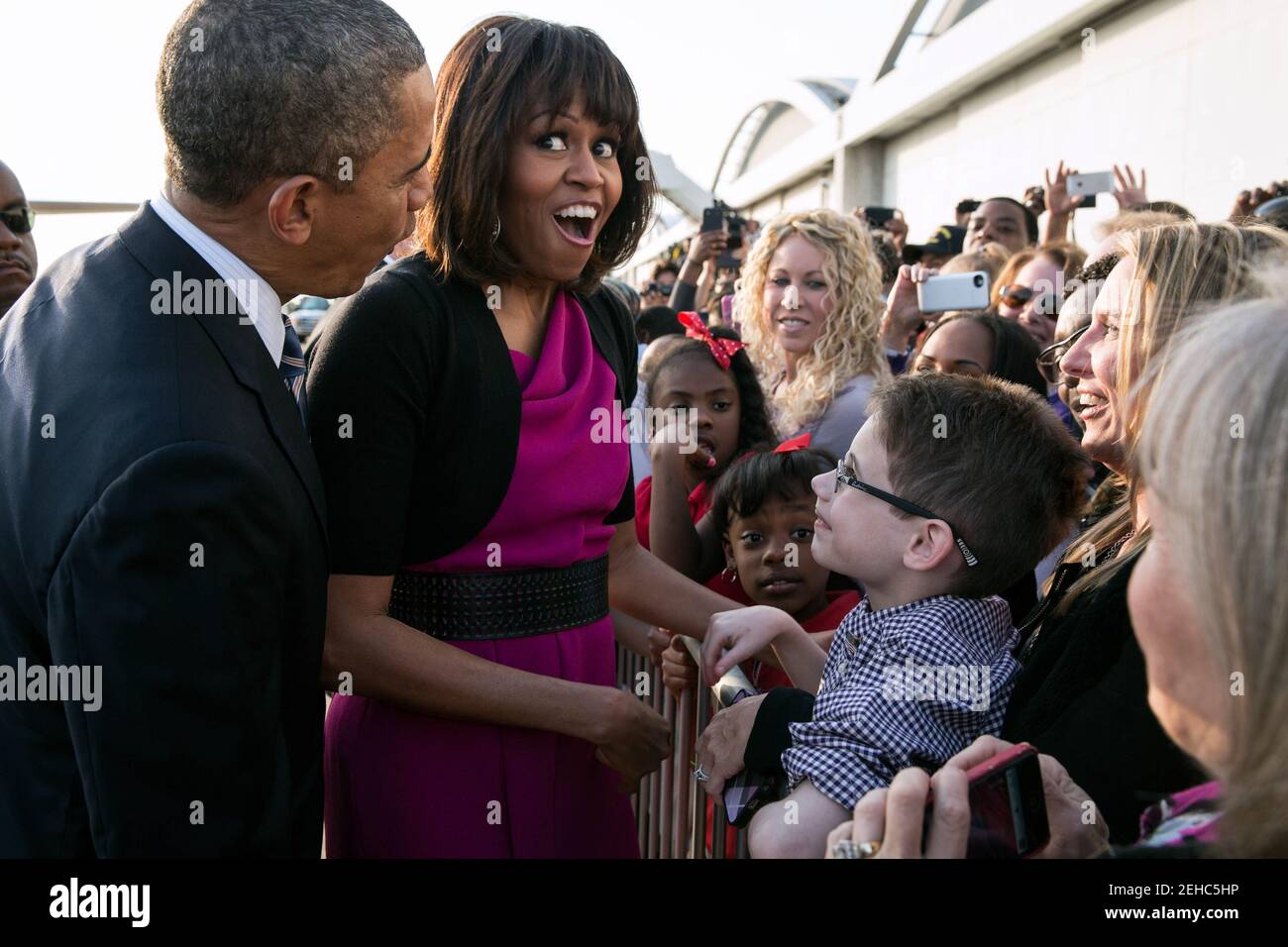 First Lady Michelle Obama reacts after President Barack Obama quieted a baby along a ropeline at Love Field Airport in Dallas, Texas, April 24, 2013. Stock Photo