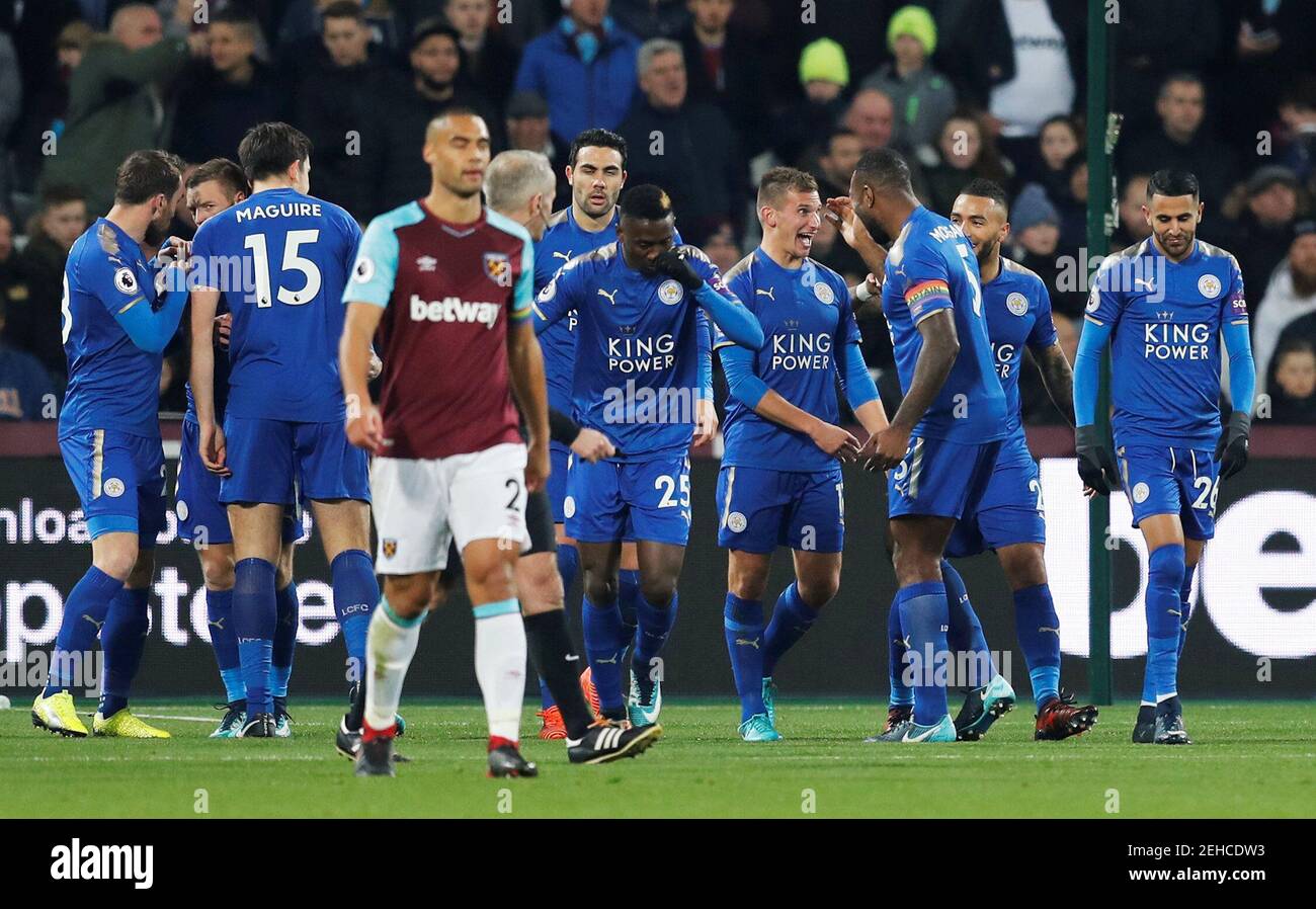 Soccer Football - Premier League - West Ham United vs Leicester City - London Stadium, London, Britain - November 24, 2017 Leicester City's Marc Albrighton celebrates scoring their first goal with team mates as West Ham United's Winston Reid looks dejected REUTERS/Eddie Keogh EDITORIAL USE ONLY. No use with unauthorized audio, video, data, fixture lists, club/league logos or "live" services. Online in-match use limited to 75 images, no video emulation. No use in betting, games or single club/league/player publications. Please contact your account representative for further details. Stock Photo