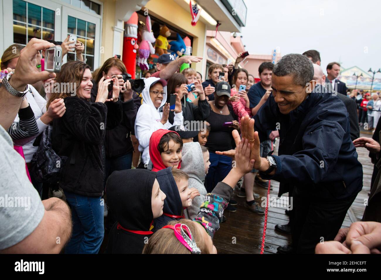 President Barack Obama high-fives kids during a visit to the Point Pleasant boardwalk in Point Pleasant Beach, N.J., May 28, 2013. Stock Photo