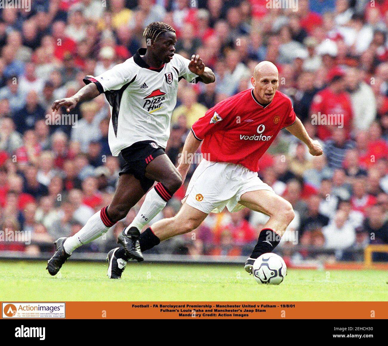 Football - FA Barclaycard Premiership - Manchester United v Fulham - 19/8/01  Fulham's Louis Saha and Manchester's Jaap Stam   Mandatory Credit: Action Images Stock Photo
