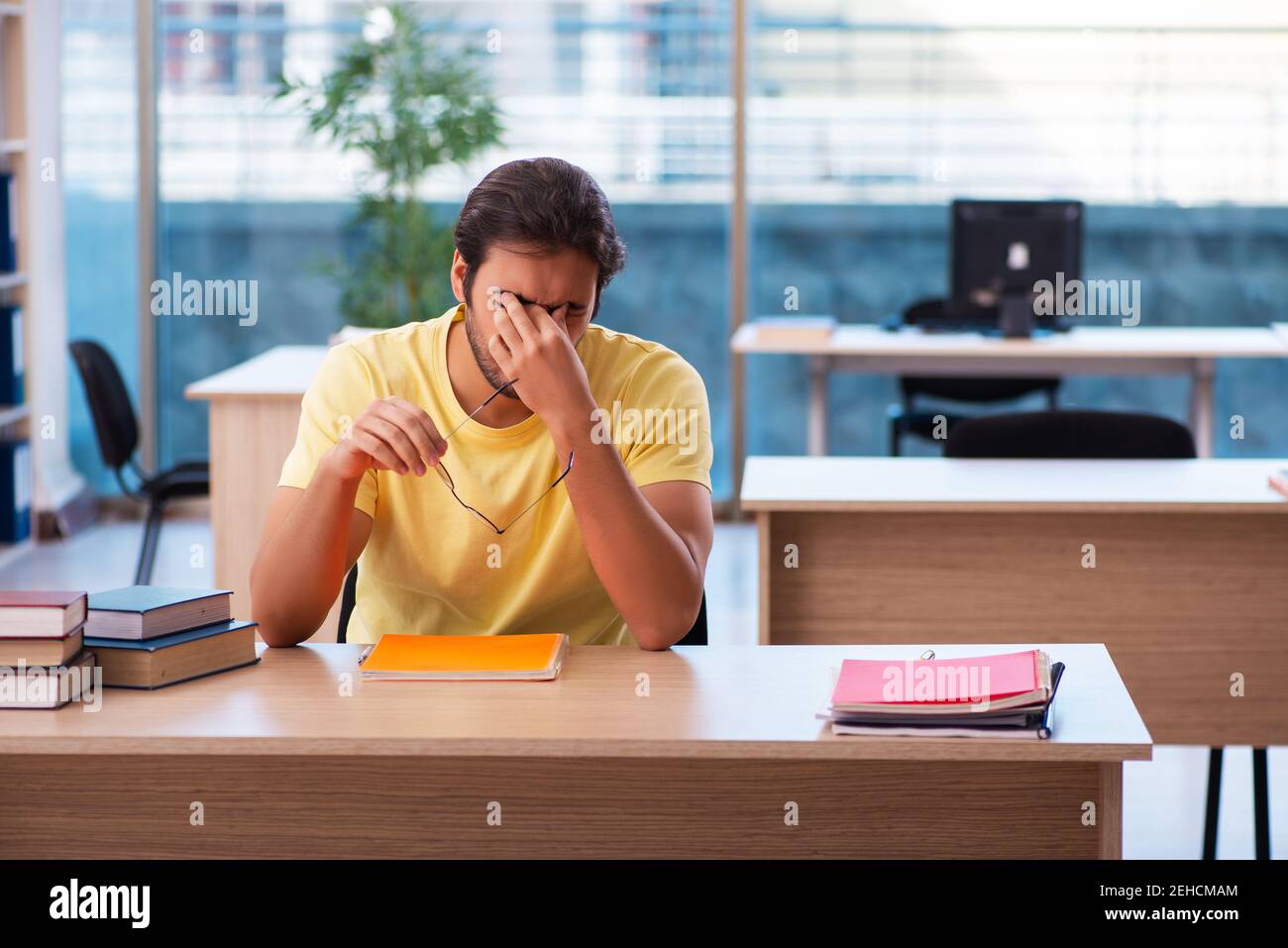 Young student preparing for exams in the classroom Stock Photo - Alamy