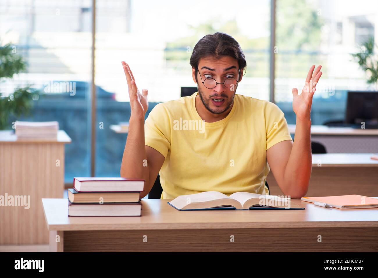 Young student preparing for exams in the classroom Stock Photo - Alamy