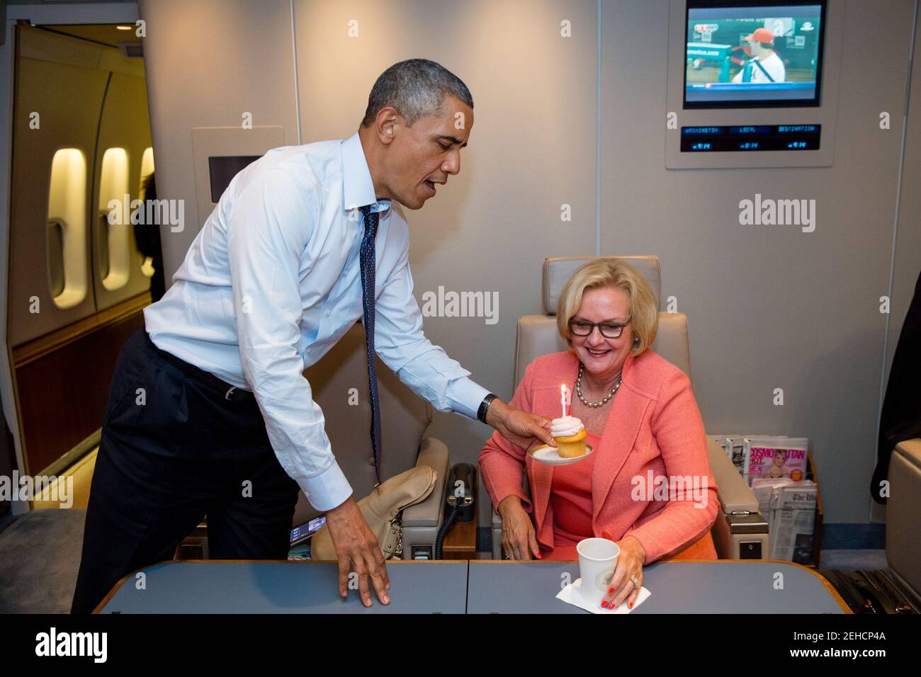 President Barack Obama presents Sen. Claire McCaskill, D-Mo., with a birthday cupcake aboard Air Force One, July 24, 2013. Stock Photo