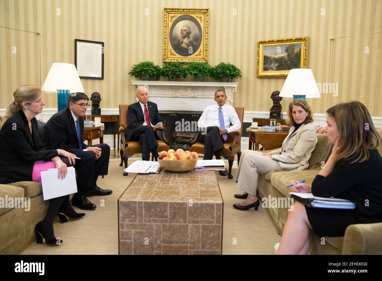 President Barack Obama and Vice President Joe Biden listen as they are updated on the federal government shutdown and the approaching debt ceiling deadline, in the Oval Office, Oct. 1, 2013. From left, Kathryn Ruemmler, Counsel to the President, Treasury Secretary Jack Lew, Sylvia Mathews Burwell, Director of OMB, and Alyssa Mastromonaco, Deputy Chief of Staff. Stock Photo
