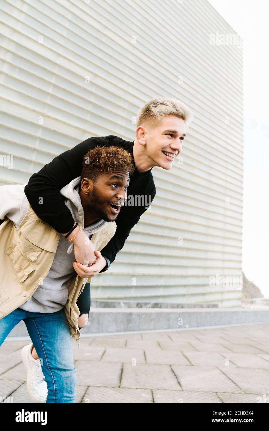 Black girl giving friend a piggyback ride Stock Photo - Alamy