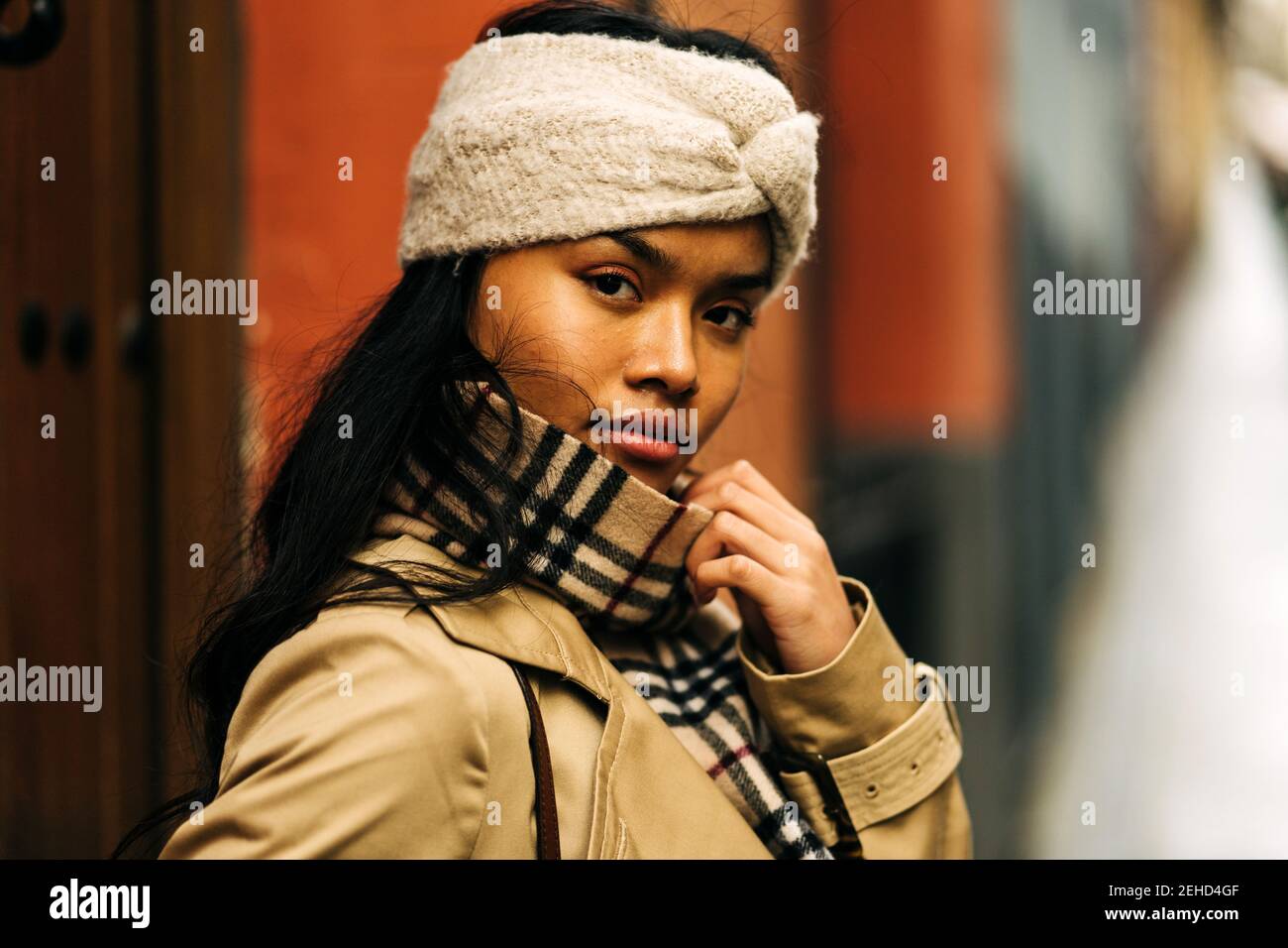 Portrait of an Asian Woman with a brown turban posing in the street