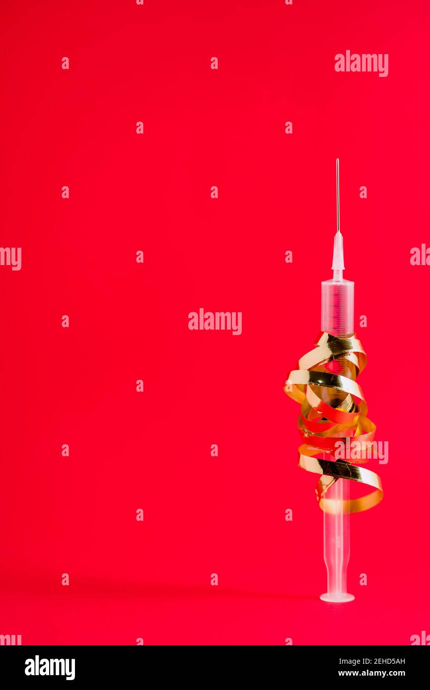 Plastic injector with curved golden ribbon and pointed needle ...