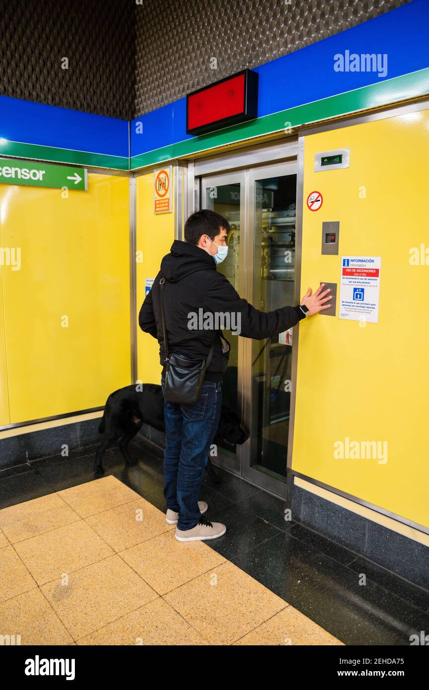 Back view full body of male with blindness in medical mask calling