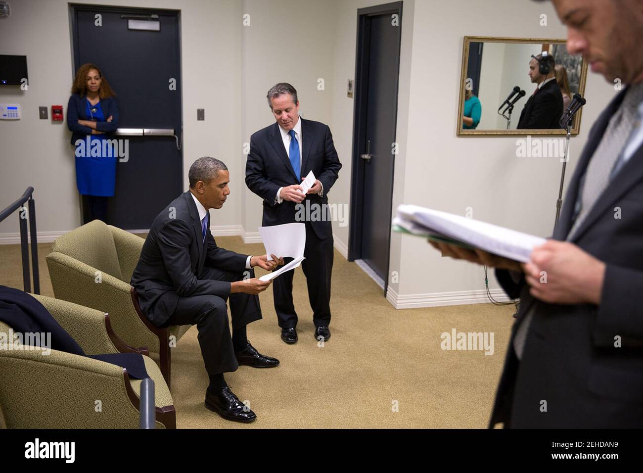 President Barack Obama reviews his notes with National Economic Council Director Gene Sperling before delivering remarks at the College Opportunity Summit in the Eisenhower Executive Office Building's South Court Auditorium, Jan. 16, 2014. Brian Mosteller, Director of Oval Office Operations, stands at right. Stock Photo