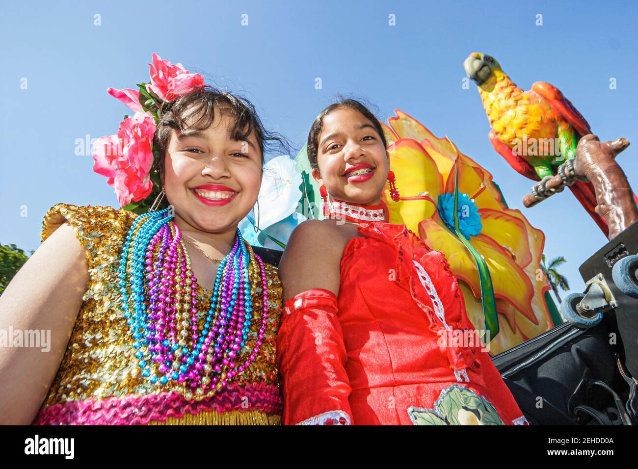 Miami Florida,Bayfront Park Greater Miami Mardi Gras Festival,Haitian Hispanic Caribbean girl girls friends wearing costumes beads float,riding, Stock Photo