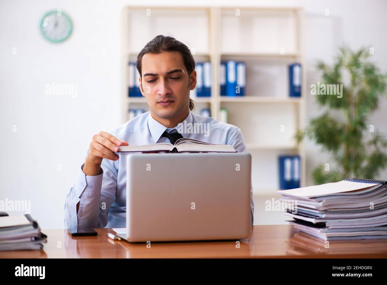 Hardworking young businessman reading documents hi-res stock ...