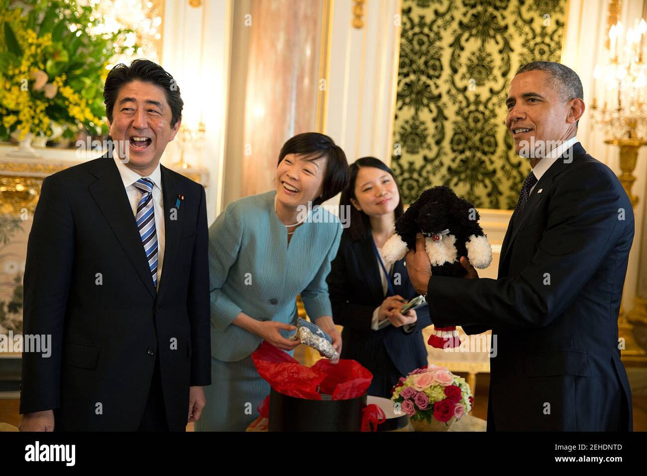 President Barack Obama holds up a Bo golf club cover, a gift given to him by Prime Minister Shinzo Abe and Mrs. Akie Abe at Akasaka Palace in Tokyo, Japan, April 24, 2104. Stock Photo