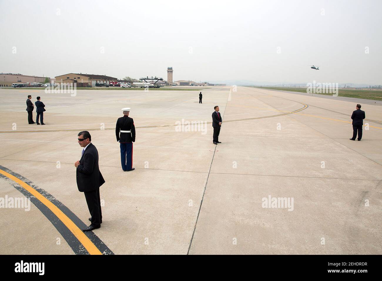 U.S. Secret Service agents are positioned on the tarmac as President Barack Obama arrives aboard Marine One at Osan Air Base, Republic of Korea, April 26, 2014. Stock Photo