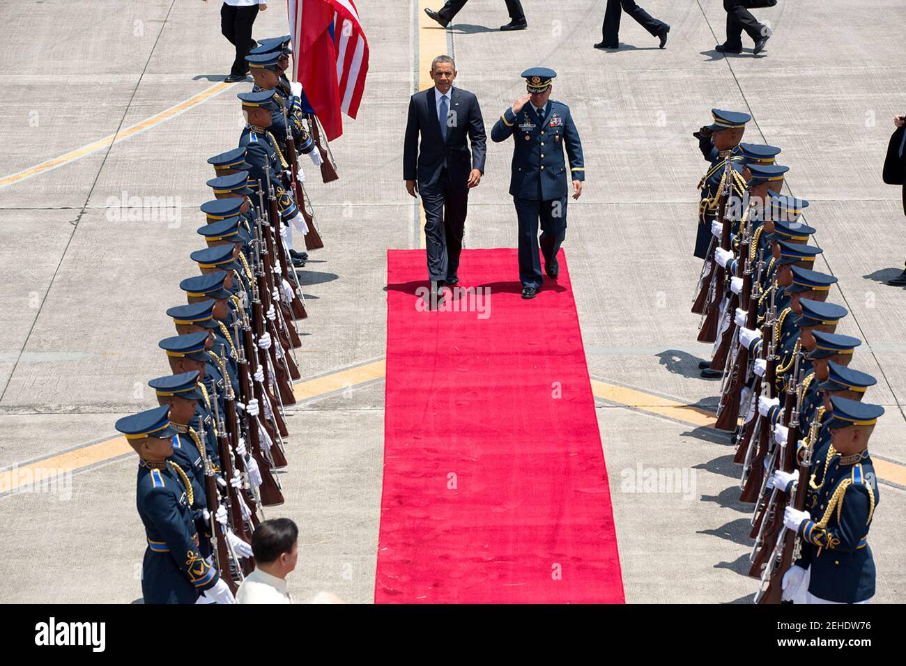 President Barack Obama, with Commanding General Jeffrey Delgado of the Philippine Air Force, walks past an honor guard at Ninoy Aquino International Airport prior to departure from Manila, Philippines, April 29, 2014. Stock Photo