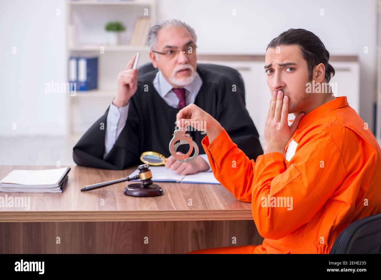 Old judge meeting with young captive in courthouse Stock Photo Alamy