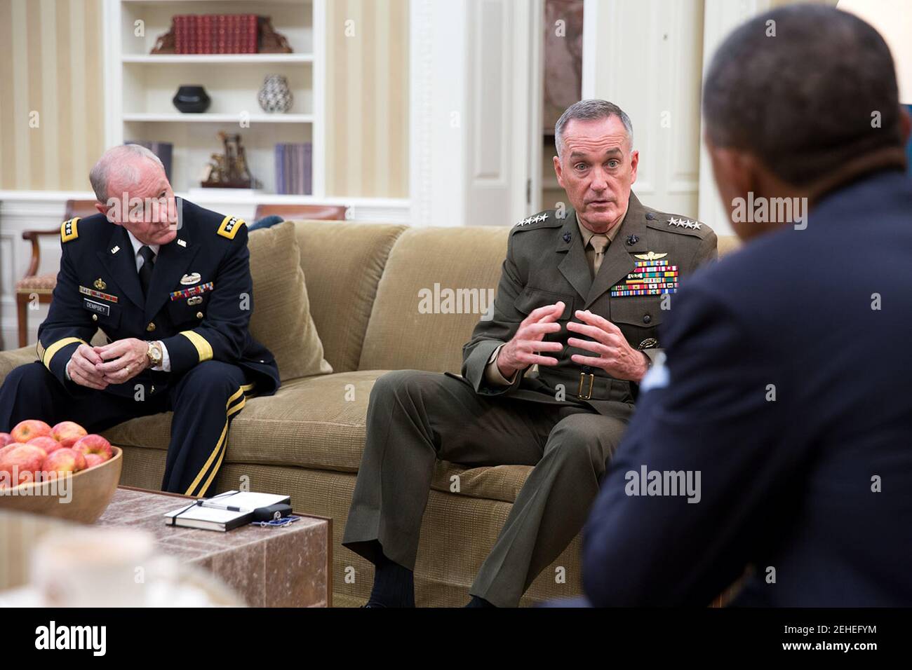 President Barack Obama meets with Gen. Joseph F. Dunford, Jr. and Gen. Martin Dempsey, Chairman of the Joint Chiefs of Staff, left, in the Oval Office, Sept. 30, 2014. Stock Photo