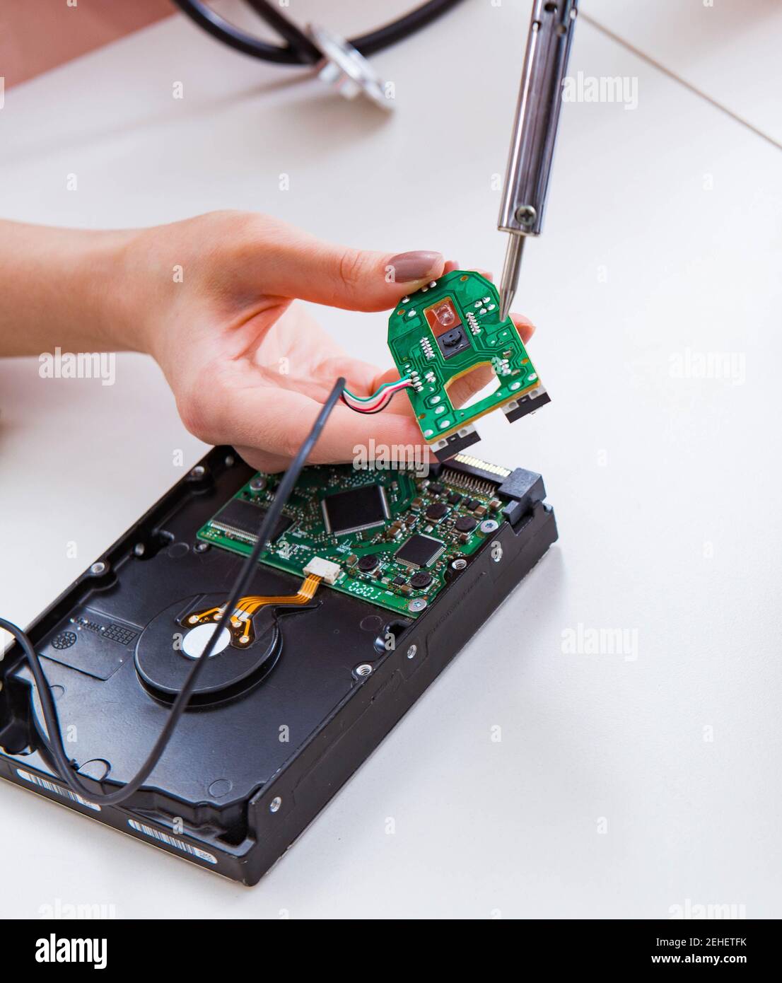 Fixing Computer Hard Way The engineer fixing broken computer hard drive Stock Photo - Alamy