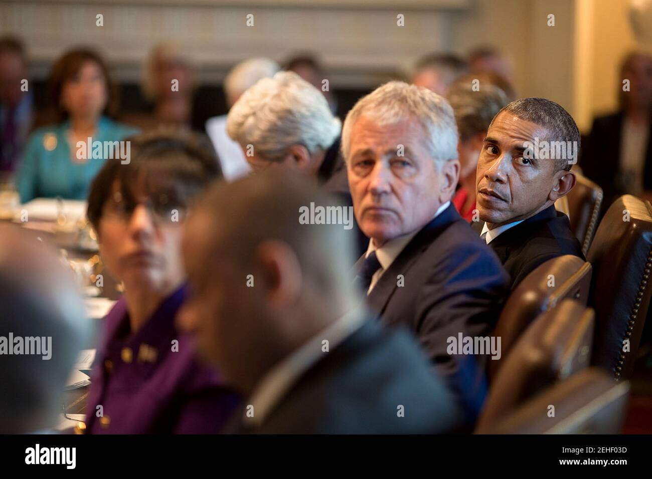 President Barack Obama, Defense Secretary Chuck Hagel and Commerce Secretary Penny Pritzker turn to listen during Cabinet meeting in the Cabinet Room of the White House, Feb. 3, 2015. Stock Photo