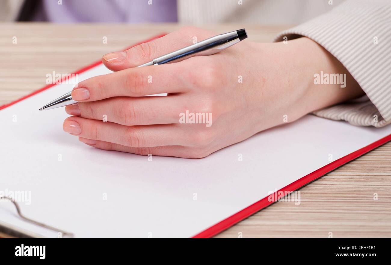 The hands taking notes in the pad Stock Photo - Alamy