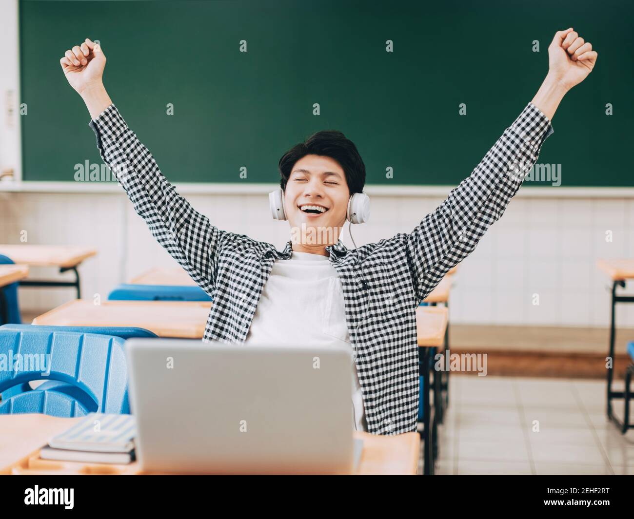 happy student wearing headphone in classroom Stock Photo Alamy