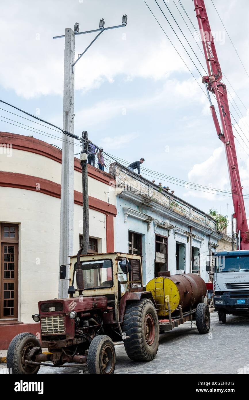 Crane and tractor working in a building repair, Santa Clara, Cuba 2014 Stock Photo