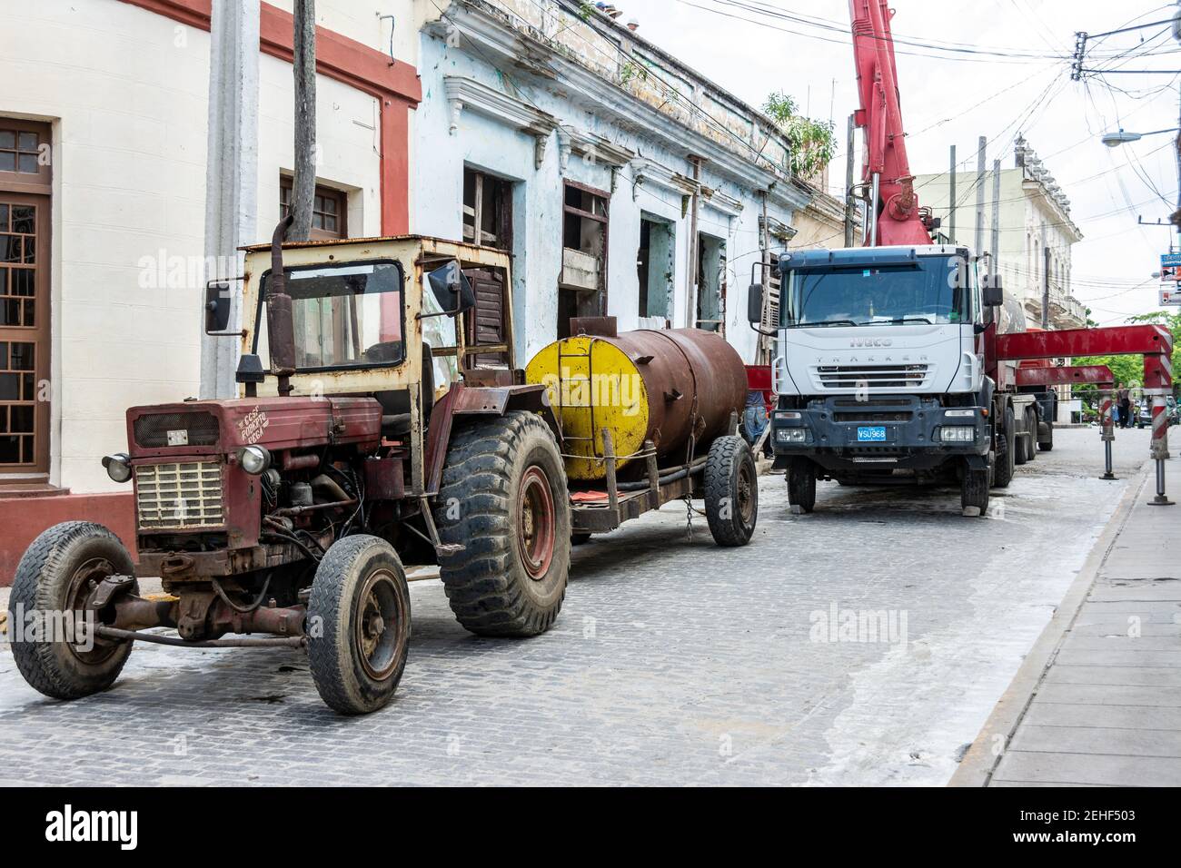 Crane and tractor working in a building repair, Santa Clara, Cuba 2014 Stock Photo