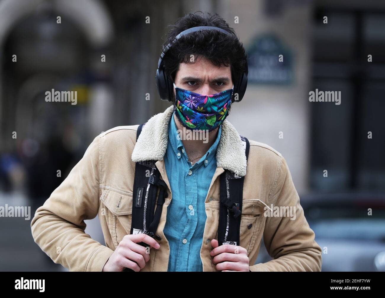 (210220) -- PARIS, Feb. 20, 2021 (Xinhua) -- A man wearing face mask walks on the street in Paris, France, Feb. 19, 2021. With 24,116 new infections confirmed in the last 24 hours, France has counted an accumulative total of 3,560,764 COVID-19 cases as of Friday, according to data from the French Public Health Agency. In a video conference with lawmakers from the ruling The Republic on the Move (LERM) party, President Emmanuel Macron said 'it's still too early to decide' whether to ease or tighten restrictions. 'We can consider hypotheses within 8 to 10 days,' he was quoted by BFMTV news Stock Photo