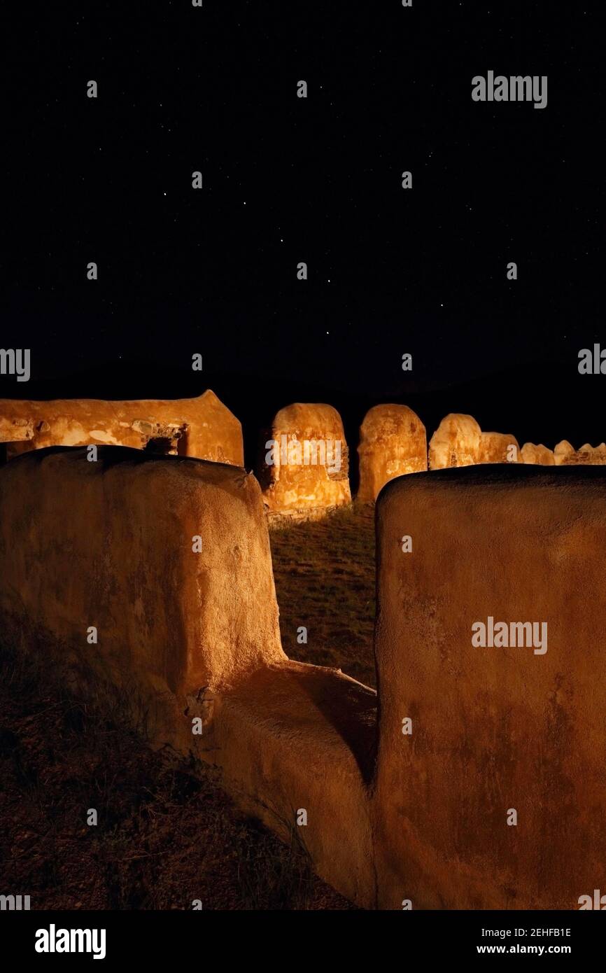 Cochise County  AZ / SEPT  Ft. Bowie National Historic Site.  Barracks ruins illuminated by flashlight with Big Dipper constellation above.  V3 Stock Photo