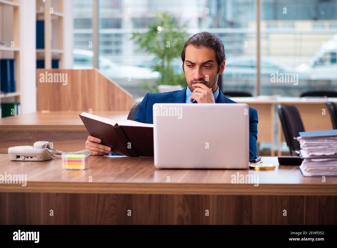 Employee Reading Young man handbook office hi-res stock photography and images - Alamy