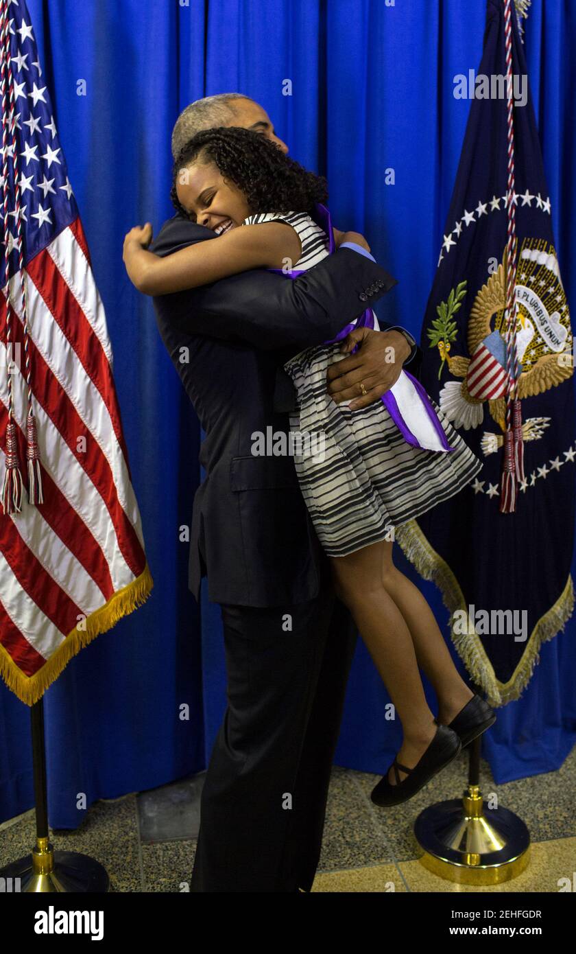 President Barack Obama hugs Mari Copeny, 8, backstage at Northwestern High School in Flint, Mich., May 4, 2016. Mari wrote a letter to the President about the Flint water crisis. Stock Photo