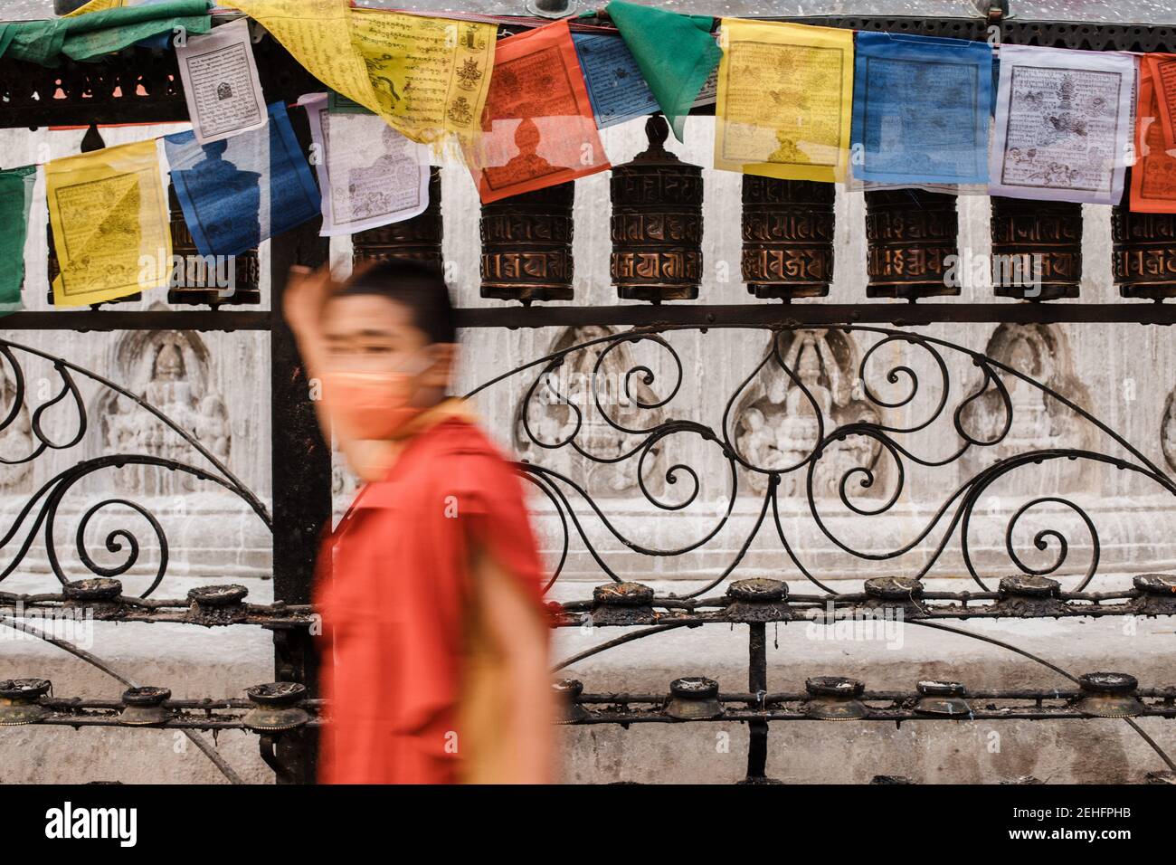 Buddhist boy walking around a buddhist temple, Kathmandu, Nepal Stock