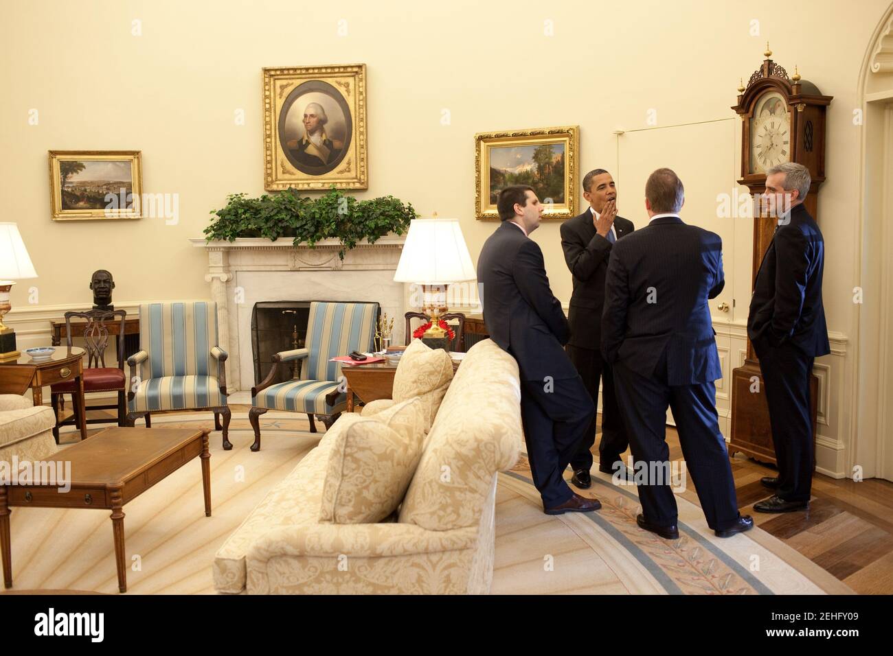 President Barack Obama talks with advisors following a meeting with ...