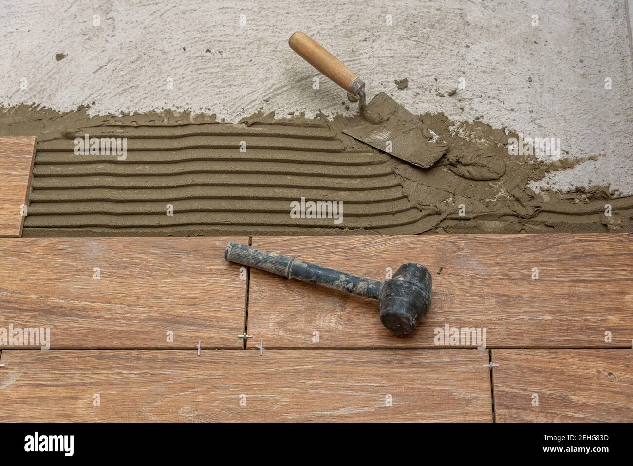 Ceramic tiles and tools for tiler. Floor tiles installation. Home