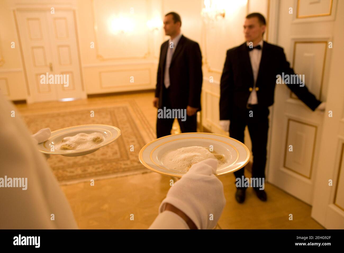 Waiters wait for their cue to serve breakfast for a meeting between President Barack Obama and Prime Minister Vladimir Putin at Putin's dacha outside Moscow, Russia, July 7, 2009. Stock Photo
