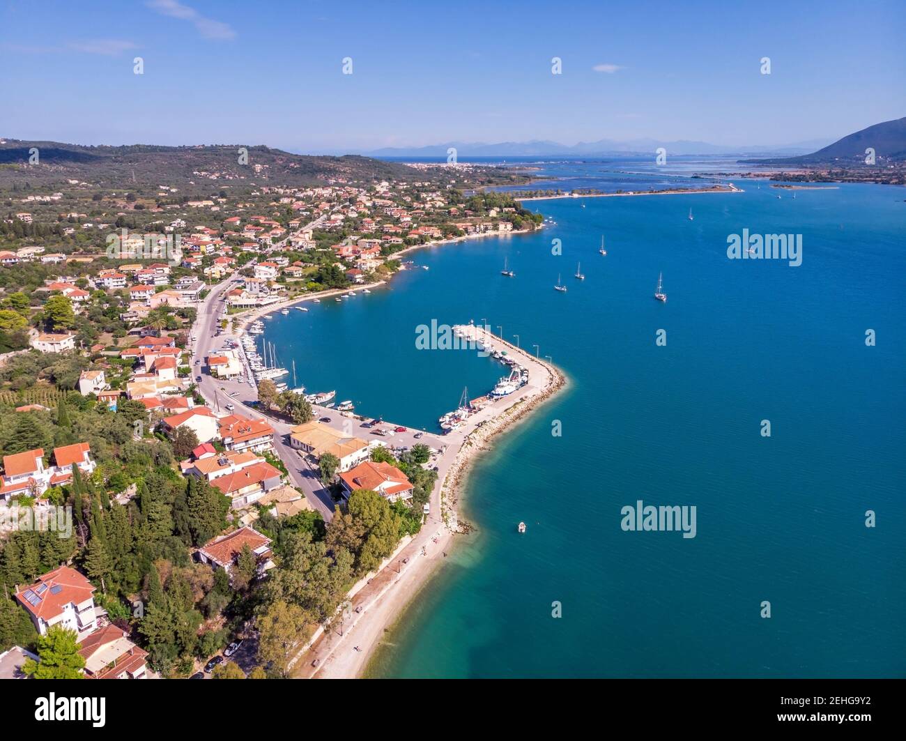 Aerial drone bird's eye view photo of iconic port of Nidri or Nydri a safe harbor for sail boats and famous for trips to Meganisi, Skorpios and other Stock Photo