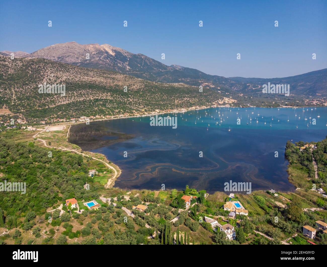 Aerial drone bird's eye view photo of iconic port of Nidri or Nydri a safe harbor for sail boats and famous for trips to Meganisi, Skorpios and other Stock Photo
