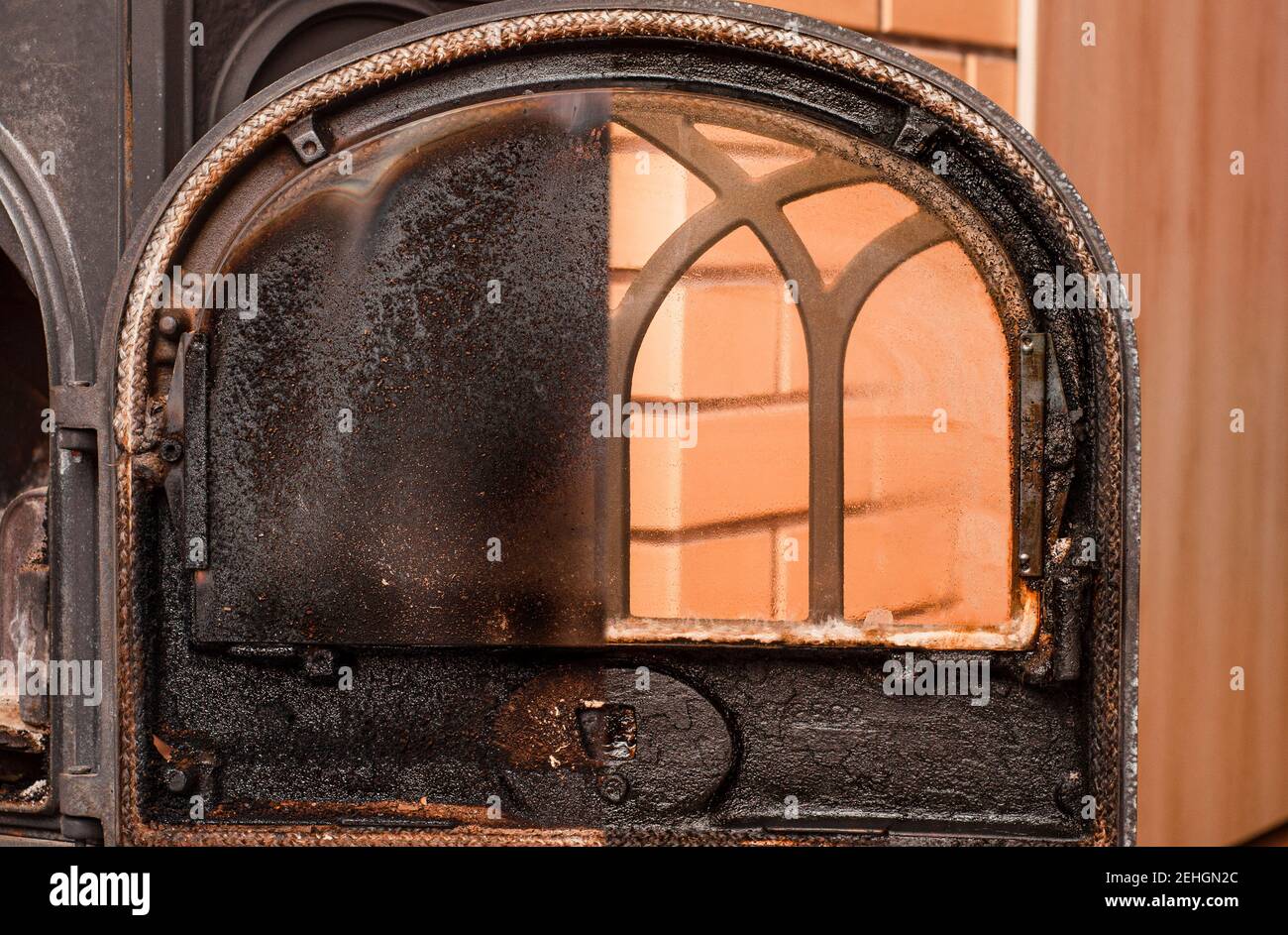 Photos before and after cleaning the furnace glass from carbon deposits and tar Stock Photo