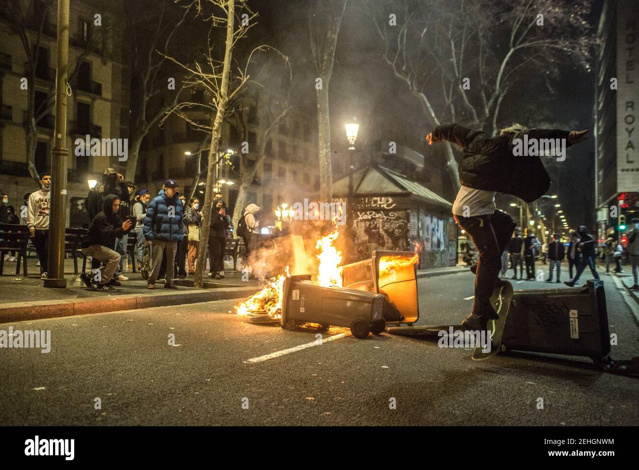 Barcelona, Spain. 19th Feb, 2021. A skateboarder spotted jumping over burning barricade during the demonstrations. Fourth night of protests and riots in response to the arrest and imprisonment of rapper Pablo Hasel accused of exalting terrorism and insulting the crown from the content of the lyrics of his songs. Credit: SOPA Images Limited/Alamy Live News Stock Photo