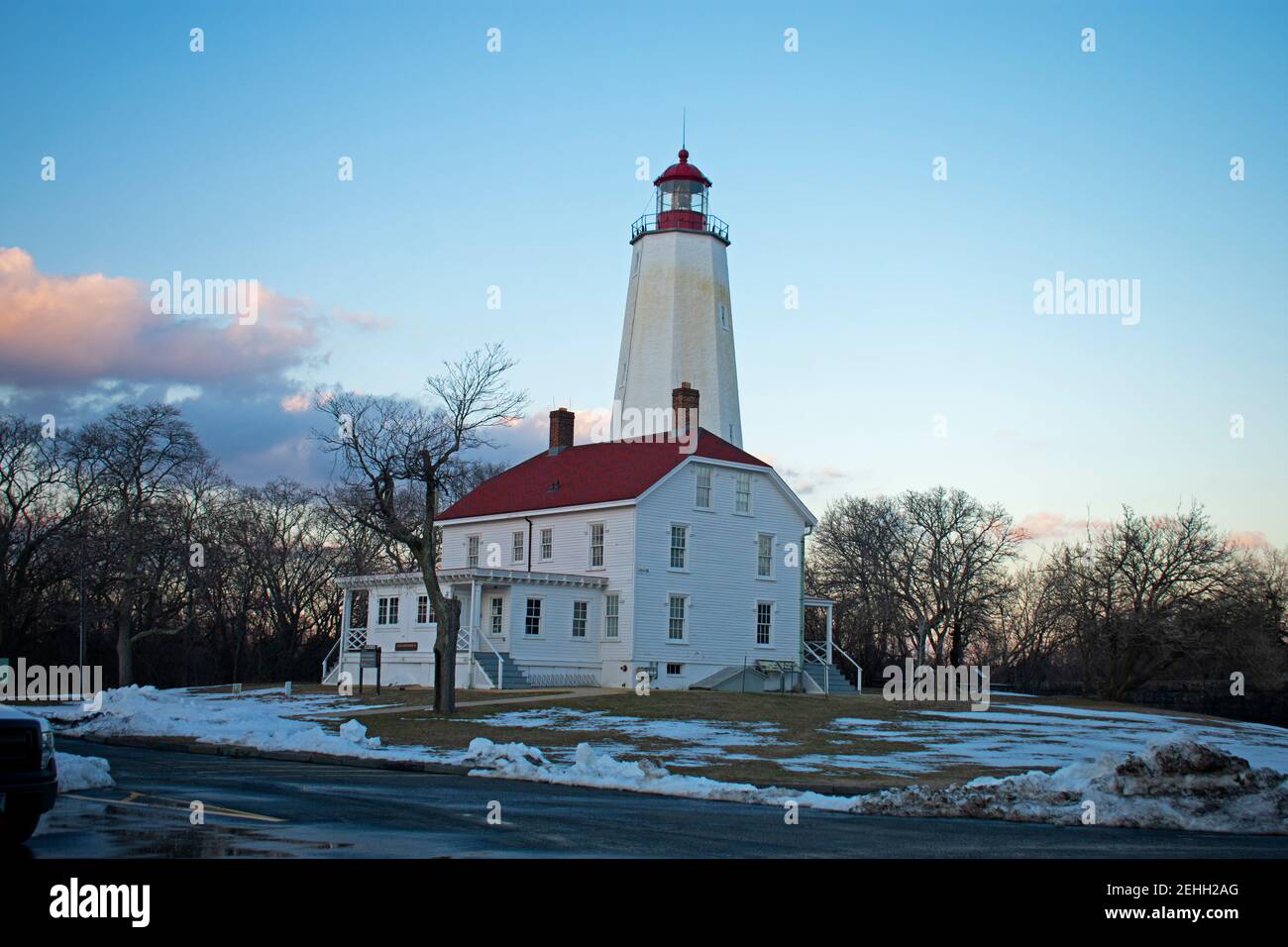Lighthouse in Sandy Hook, New Jersey, in a late winter afternoon, with snow still on the ground and the light turned off  -38 Stock Photo