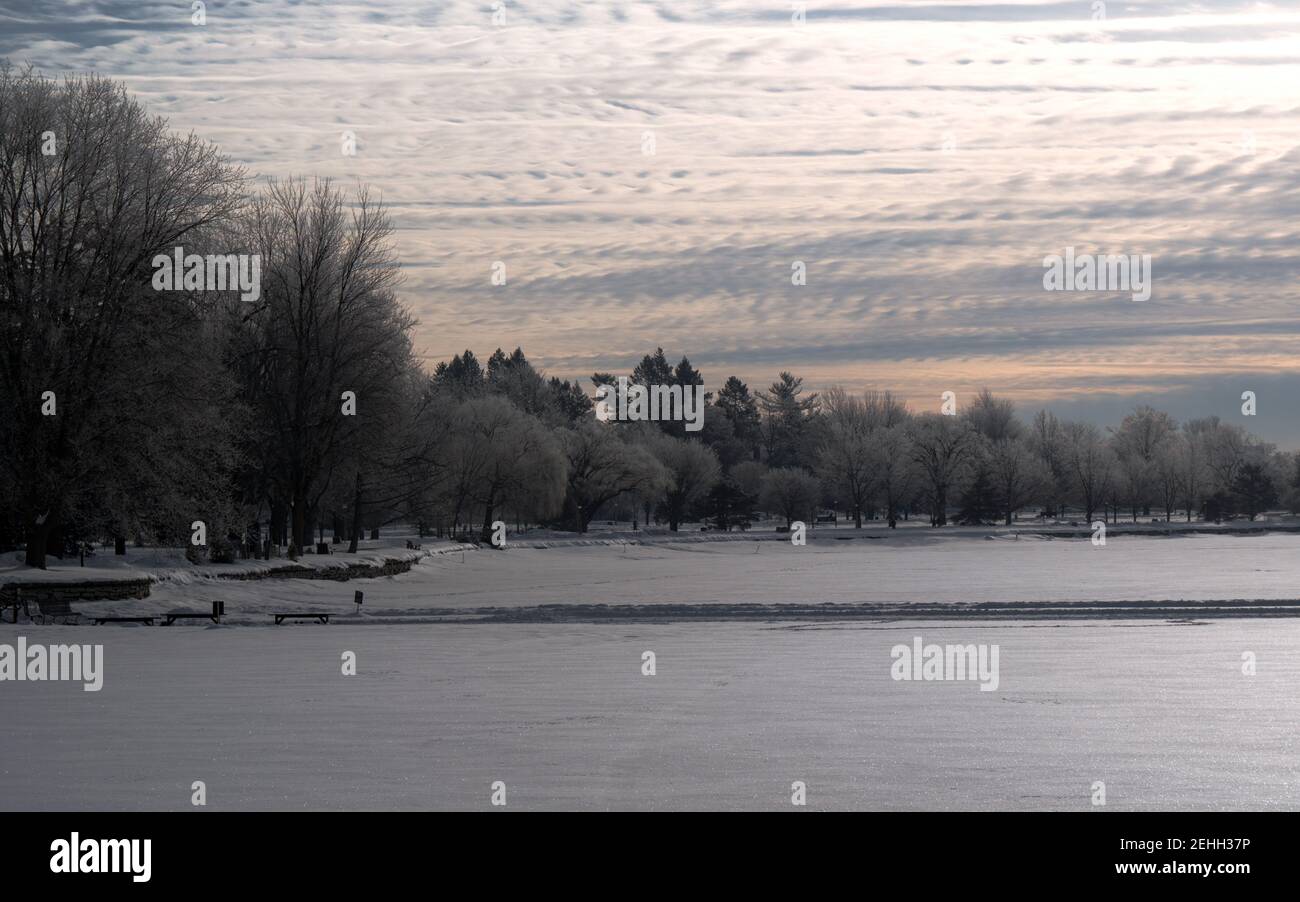 Canadian landscapes - spectacular soft, pale winter sunrise over a frozen Dow's Lake, Ottawa, Ontario, Canada. Stock Photo