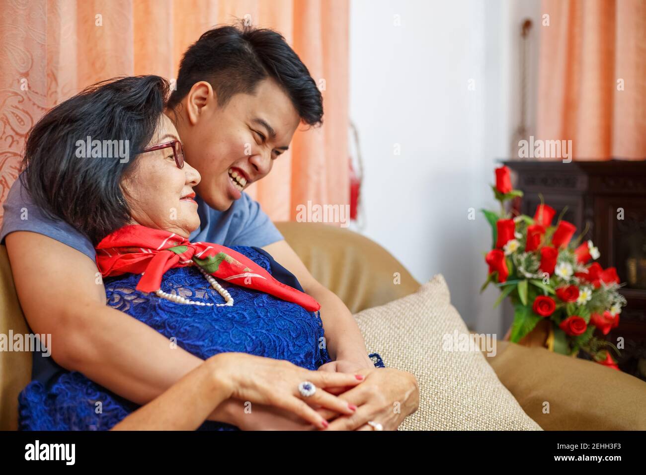 Adult son comimg home and hug mother on the mothers day Stock Photo