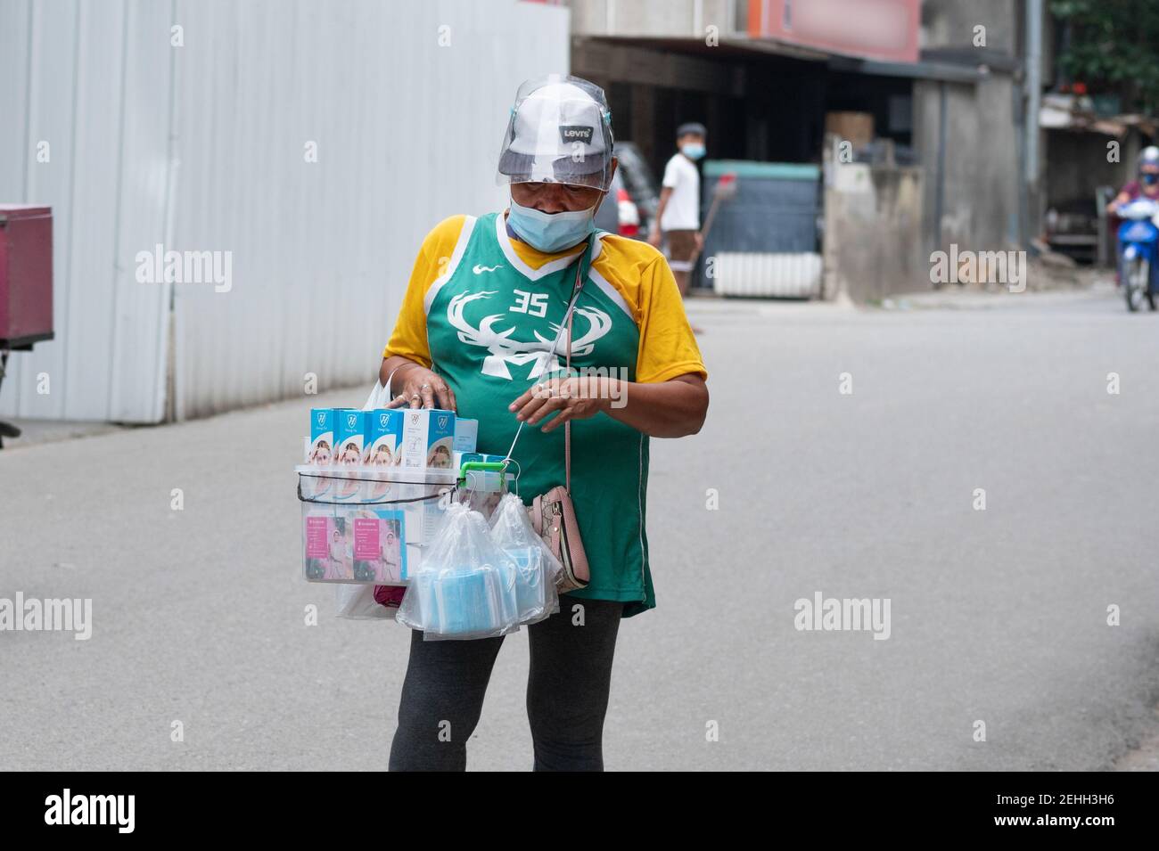 A Filipino woman selling face masks and face shields, Cebu City