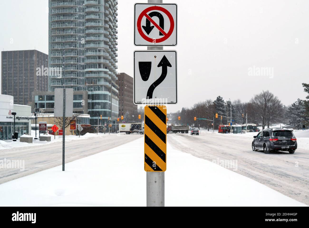 Life in a cold city - snowscapes from Ottawa - road signage on a traffic light in the middle of a snowy Carling Ave. Ontario, Canada. Stock Photo