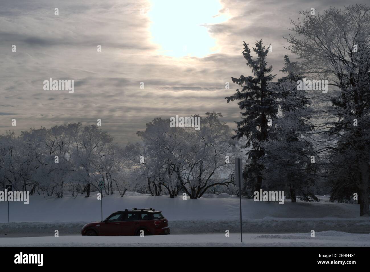 Life in a cold city - winterscapes from Ottawa - red car on Carling Ave at Preston on a beautiful icy winter morning sunrise. Ontario, Canada. Stock Photo