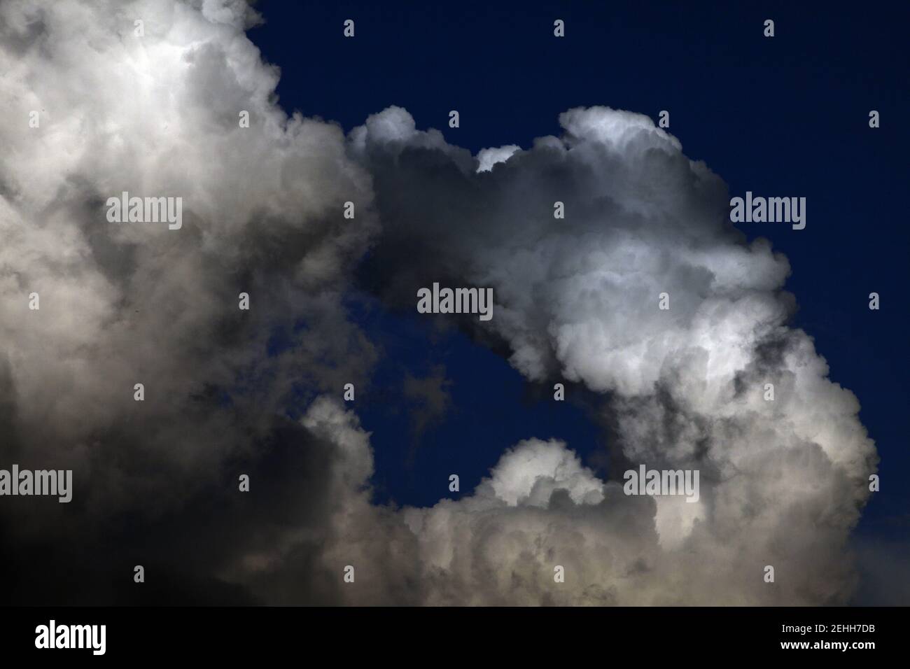 Low angle of partly dark clouds in the sky with copy Stock Photo - Alamy