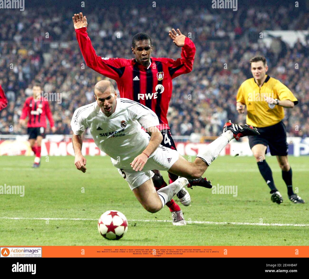 Football - Real Madrid v Bayer Leverkusen UEFA Champions League Group B -  Estadio Santiago Bernabeu - 23/11/04 Real Madrid's Zinedine Zidane in  action being fouled and brought down by Leverkusen's Juan