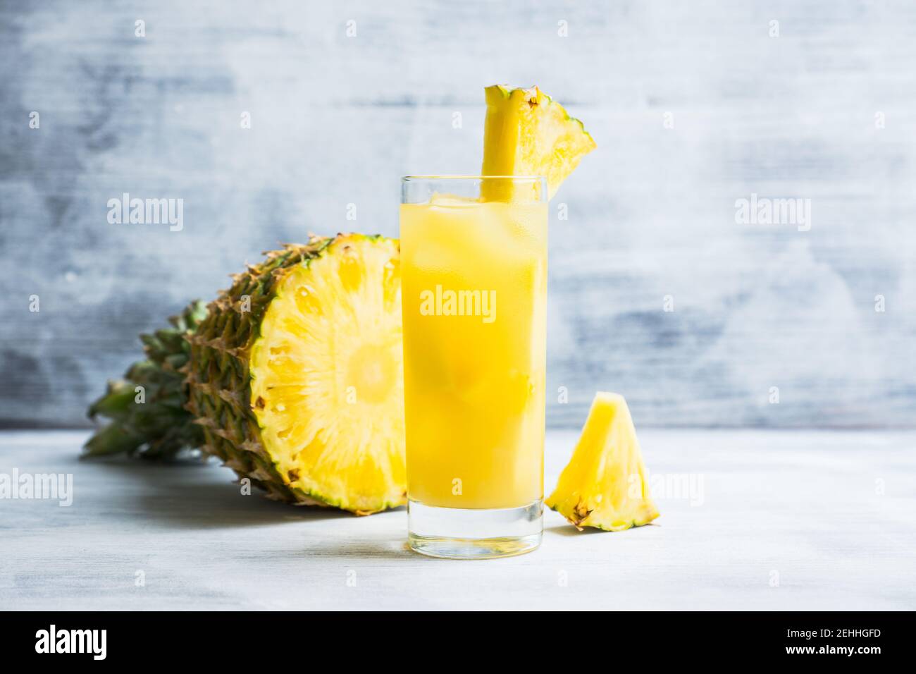 Fresh pineapple beverage on rustic background. Selective focus. Shallow depth of field. Stock Photo