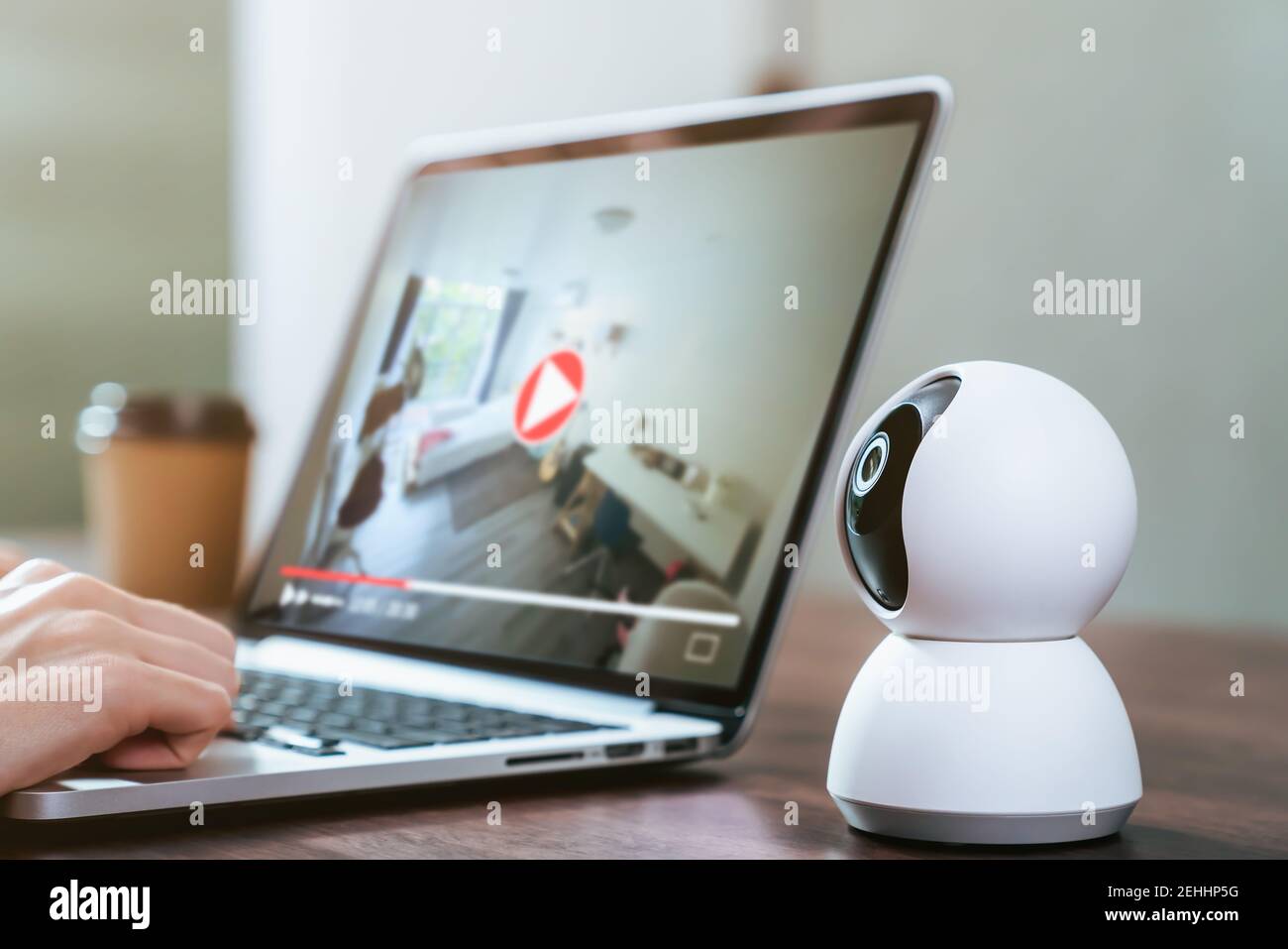 Security CCTV camera on the table and using laptop with looking video record, surveillance technology. Stock Photo