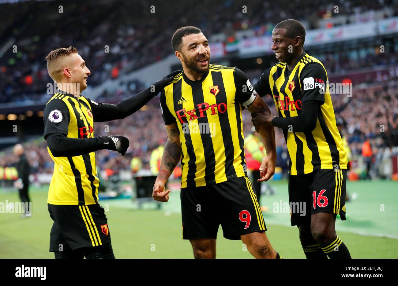 Soccer Football - Premier League - West Ham United v Watford - London Stadium, London, Britain - December 22, 2018  Watford's Troy Deeney celebrates scoring their first goal with Abdoulaye Doucoure and Gerard Deulofeu   REUTERS/Eddie Keogh  EDITORIAL USE ONLY. No use with unauthorized audio, video, data, fixture lists, club/league logos or 'live' services. Online in-match use limited to 75 images, no video emulation. No use in betting, games or single club/league/player publications.  Please contact your account representative for further details. Stock Photo